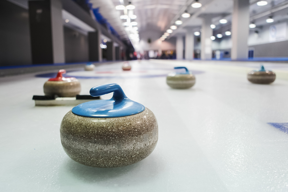 Curling,Stones,Lined,Up,On,The,Playing,Field