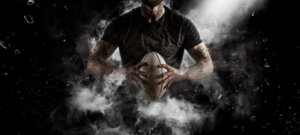Rugby,Player,In,Action,On,Dark,Arena,Background